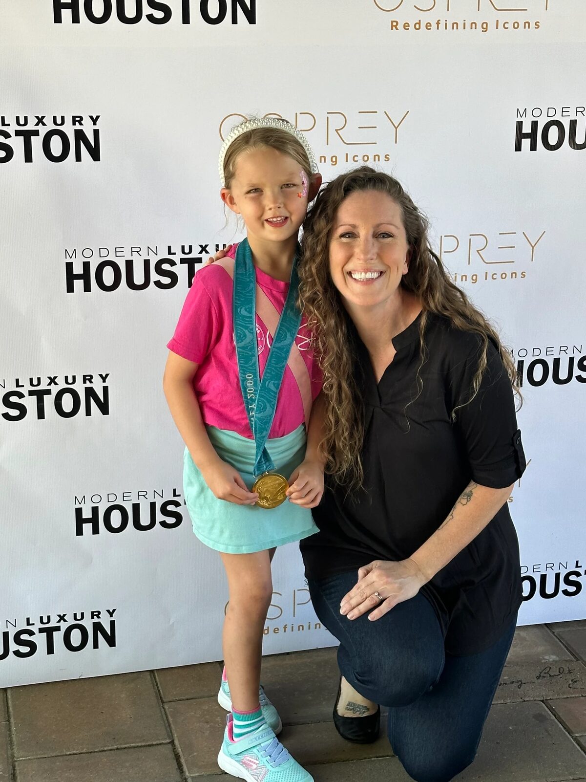 Young girl with a medal at an Osprey Collective event